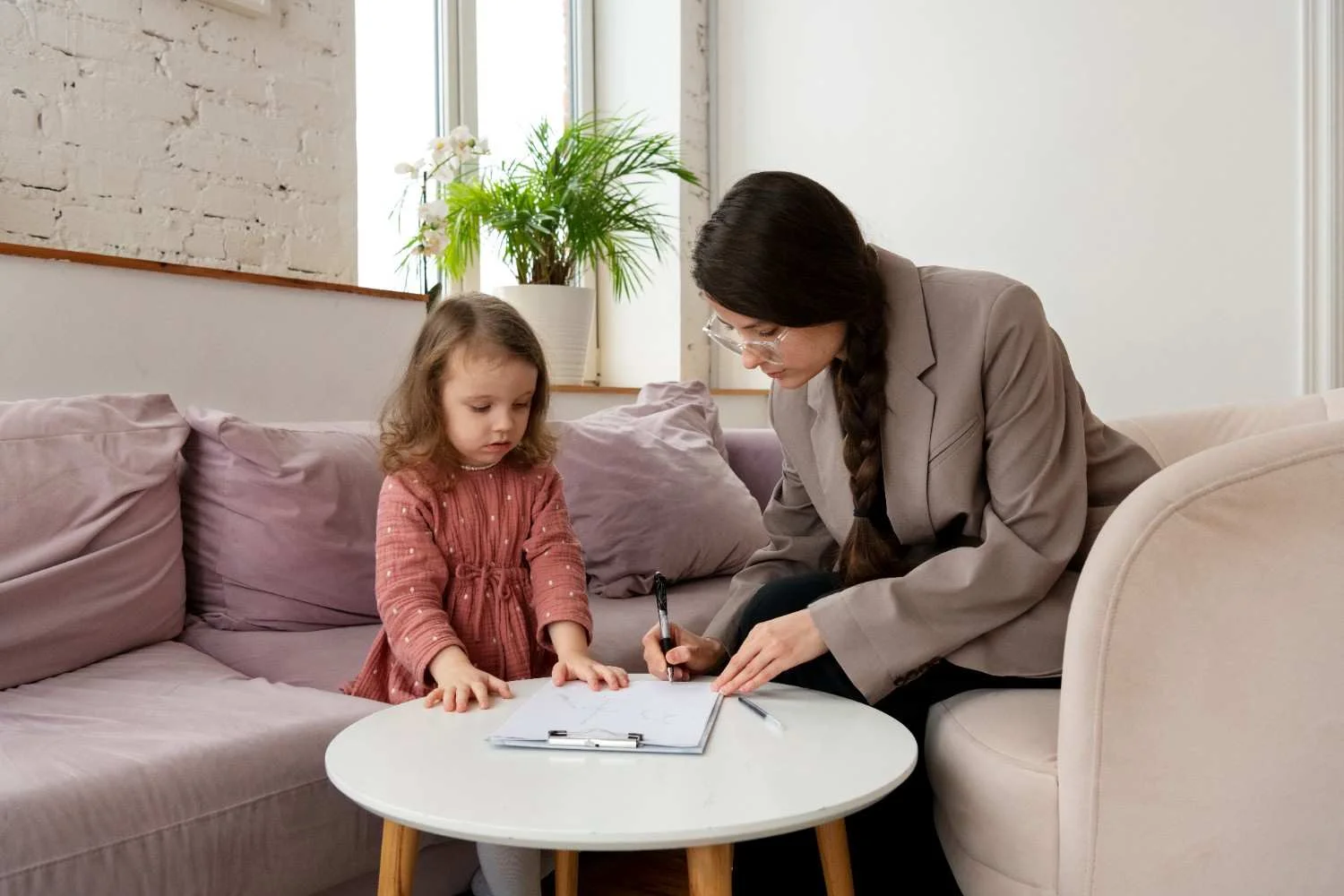 A child speaks with a family consultant during a child impact report interview.