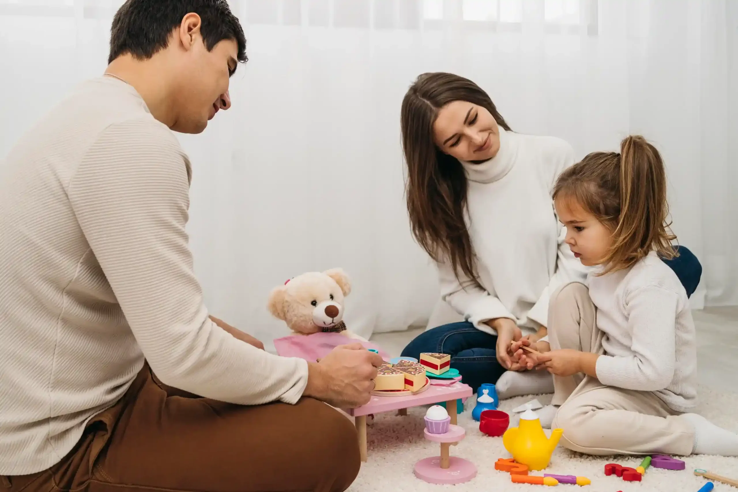 Parents and child playing together at home, showing family bonding in a warm living space