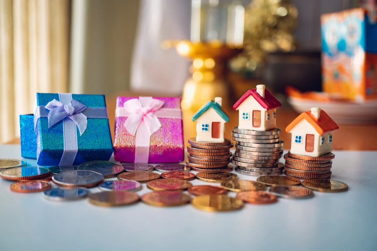 Miniature houses on stacks of coins representing property investment